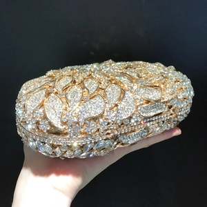 Macro detail of luxury gold leaf evening clutch bag with sparkling diamond crystal studs