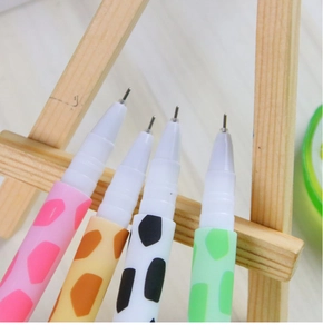 Close-up of giraffe patterned gel pens with colorful animal spots and fine metal tips