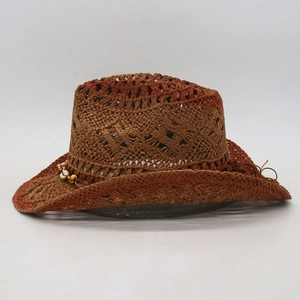 Detail of woven straw cowboy hat with shell beads and bohemian gradient finish