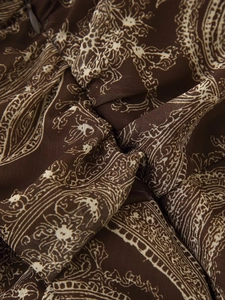 Close-up of vintage paisley print chiffon fabric with hidden zipper detail