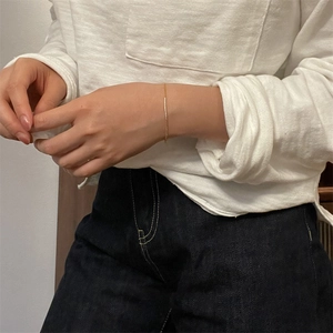 Detail of minimalist gold chain bracelet with delicate pavé set crystals on wrist