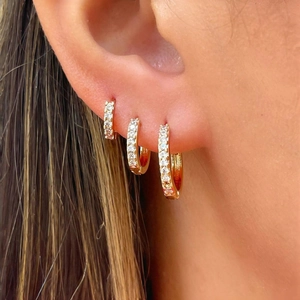 Three-piece set of gold hoop earrings with sparkling cubic zirconia for a layered look