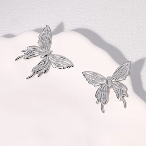 Minimalist silver butterfly stud earrings in polished stainless steel for women