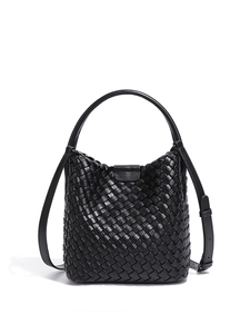 Minimalist black hand-woven leather bucket bag with top handle and adjustable strap