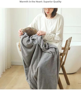 Detailed texture of thick dark grey coral fleece bath towel with vertical ribbed patterns