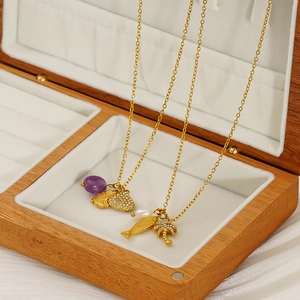 Gold-plated ocean theme necklace with pearl, shell, and palm pendants in wooden box