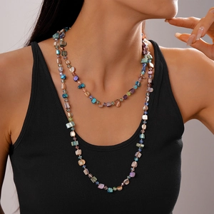 Detail of layered beach style necklace with irregular faux pearls and crystals