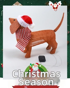 Close-up of lighted dachshund figure with battery box and holiday scarf detail