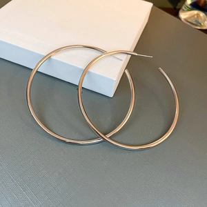 Close-up of classic silver metal hoop earrings with a polished minimalist round design