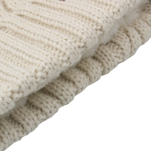 Close-up of beige cable knit beanie with thick thermal fleece lining for winter