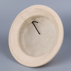Macro view of beige knit hat interior featuring adjustable inner drawstring and sweatband