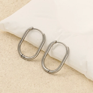 Close-up of polished silver geometric oval hoop earrings with a secure hinged closure