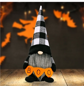 Detail of Halloween gnome with black and white plaid hat and BOO pumpkin accessories
