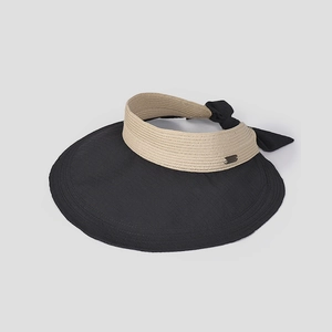 Detail of summer sun hat featuring woven head strap, metal logo plate and black bow tie