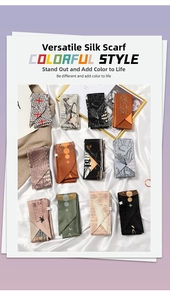 Flat lay of multiple French style silk scarves with elegant patterns on white satin