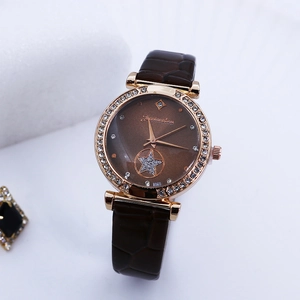 Detailed macro view of a rose gold quartz watch with rhinestones and star pattern