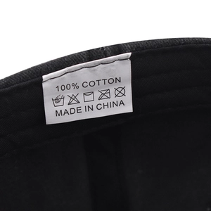 Detailed macro view of 100% cotton wash care label and stitching inside the baseball cap