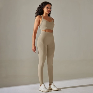 Detail of seamless yoga set with racerback top and high waist leggings in beige
