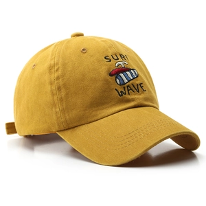 Unisex washed cotton baseball cap in mustard yellow with surf wave embroidery detail