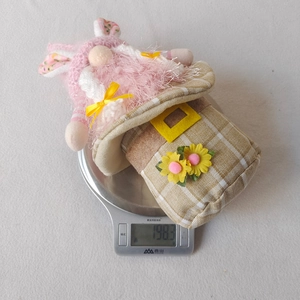 Detailed view showing a plush Easter gnome doll on a scale weighing exactly 198.3 grams
