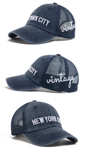 Detail of vintage washed navy blue trucker hat with New York City embroidery and mesh back