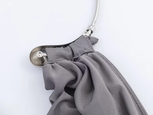 Detail of grey fabric texture with premium silver metal buckle and frame on elegant dress