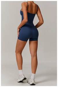 Rear view of navy blue high-stretch yoga set with cross-back sports bra and biker shorts