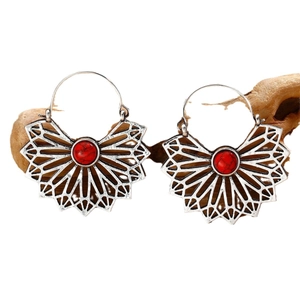 Bohemian fan-shaped silver drop earrings featuring center red stones on wood stand