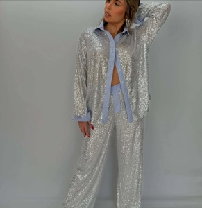 Detail of silver sequined two-piece set with light blue striped cuffs and elastic waist