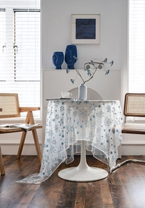 Detailed view of white mesh tablecloth featuring delicate blue snowflake star patterns