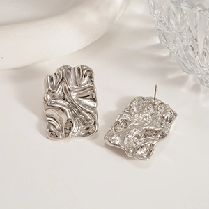 Detailed view of silver irregular liquid metal crumpled earrings with high mirror polish