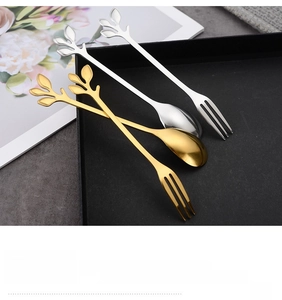 Close-up of leaf-shaped gold and silver stainless steel spoons with smooth polished edges