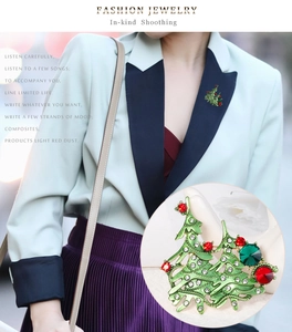 Detail view of rhinestone Christmas tree brooch on a model with enamel finish