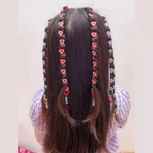 Detail of colorful strawberry and heart beads in a girl's braided hairstyle