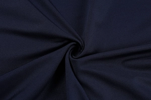 Macro view of navy blue fabric with fine diagonal twill texture and silky luster