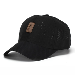Detail of breathable mesh fabric on black baseball cap with brown leather patch