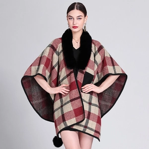 Women's plaid poncho with black faux rabbit fur collar and decorative pom poms