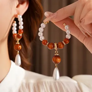 Retro resin drop pearl earrings with amber cat-eye beads and elegant metal ring design