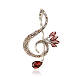 Elegant treble clef musical note brooch with colorful rhinestones on a white background