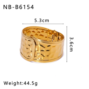 Detail showing dimensions of wide hammered gold bangle with 3.6cm width and 5.3cm diameter