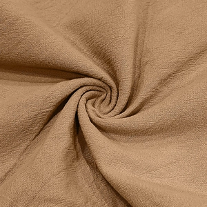 Close-up of brown linen fabric texture showing detailed weave and soft drapery
