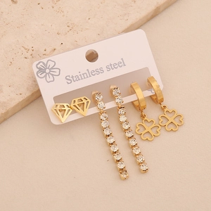 Three pairs of gold-plated stainless steel earrings with rhinestones and clover pendants