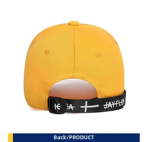 Rear view of yellow street style baseball cap with printed long ribbon and buckle