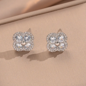 Elegant silver four-petal flower stud earrings with sparkling cubic zirconia inlay
