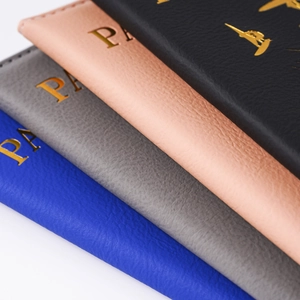 Macro detail of lychee texture and gold foil lettering on PU leather passport covers