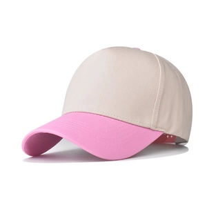 Detail of two-tone cotton baseball cap showing beige crown and pink curved brim