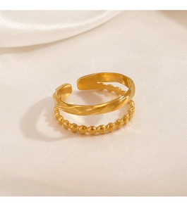 Detail of gold-plated double-layer stainless steel ring with wave twist and bead design