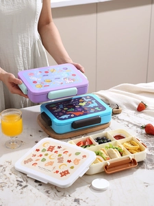 Three multi-compartment bento lunch boxes with space, dinosaur, and bear themes for students