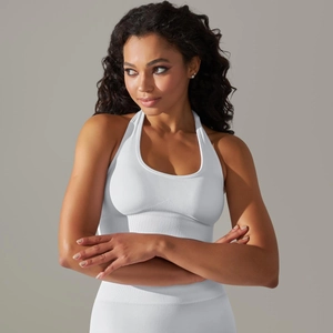 Macro shot of white ribbed seamless halter-neck sports bra with fitted athletic texture