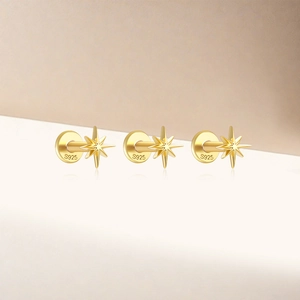 Detailed macro view of three golden S925 sterling silver eight-pointed star flat back earrings